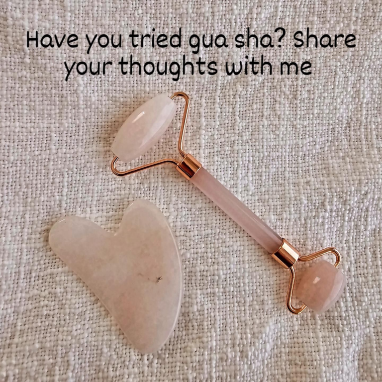 there is a rose quartz stone roller with a rose quartz heart on it